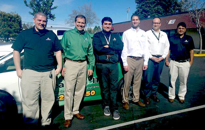 Jon Simms, in green, with his TeamLogic IT of Mountain View team.