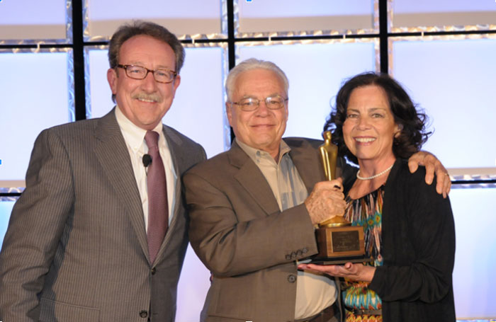 Davis and Barbara Merrey receive the 2013 Franchisee of the Year Award from TeamLogic IT President Chuck Lennon, at left.