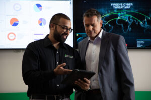 Tech and owner talkin over tablet